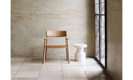 Interior scene with a wooden chair beside a white Bit Stool, placed near a tall industrial-style window.